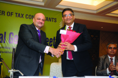 CA Hinesh R. Doshi, Imm. Past President offering Bouquet to incoming President CA Vipul K. Choksi